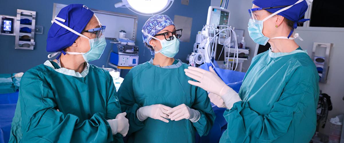 Three surgeons talking in OR