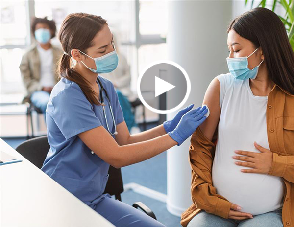 Provider administering a vaccine to pregnant patient.