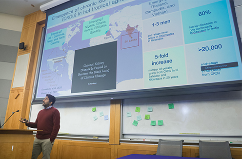 Nishad Jayasundara, PhD in front of podium doing a presentation at Climate Action Day