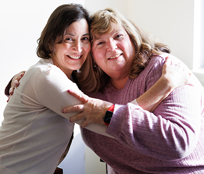 Two people embracing and smiling.