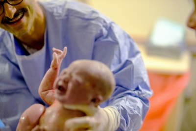 Dr. Clayton Alfonso delivering a baby
