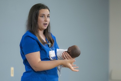 A provider teaches an in-person "preparing for baby" class
