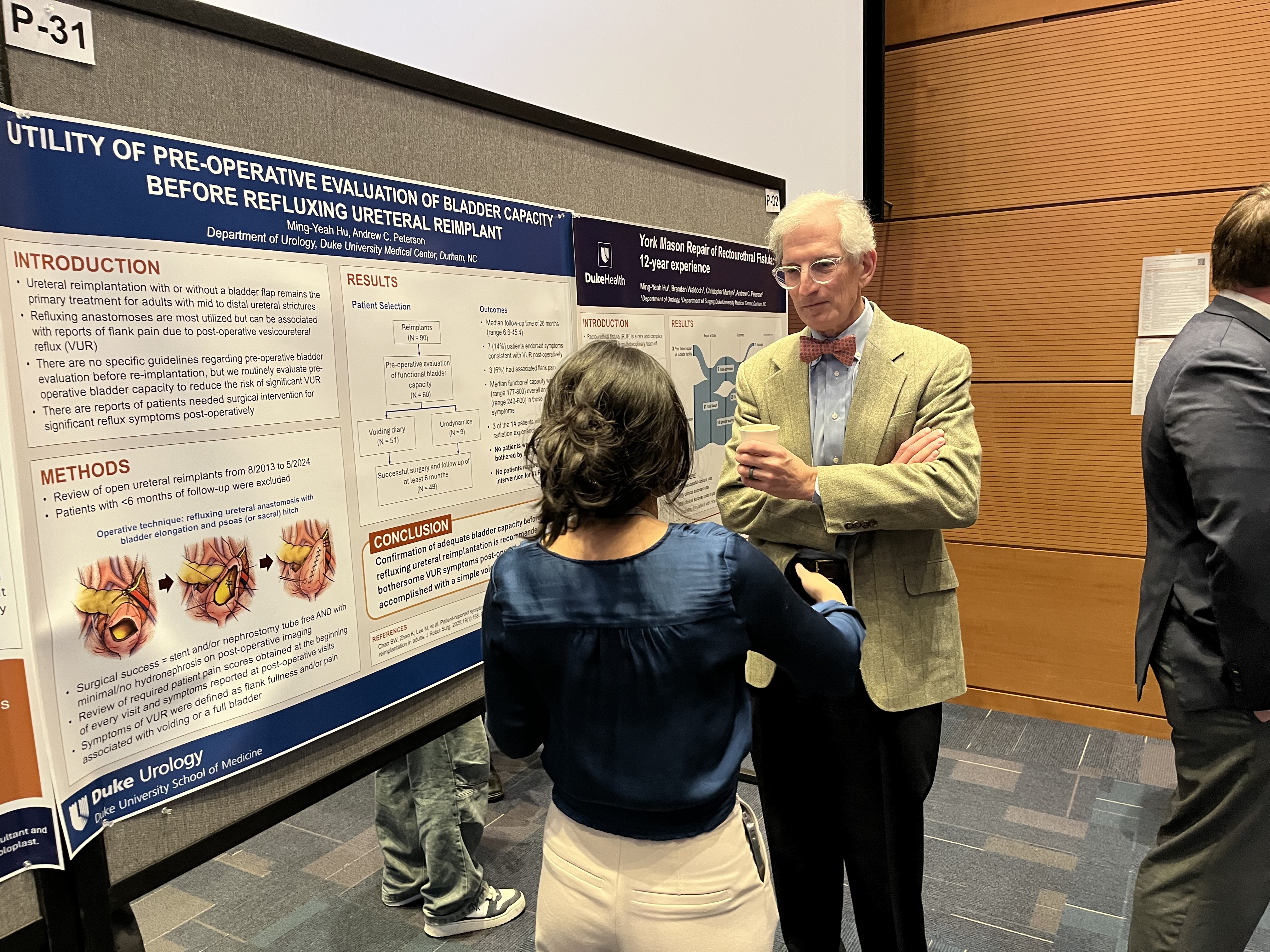 Two people discussing research poster.