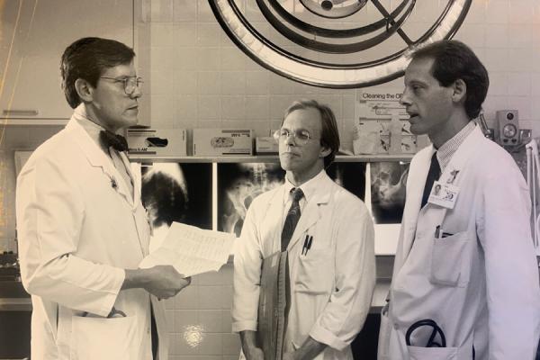 Daniel Clarke-Pearson, MD, then chief of the Division of Gynecologic Oncology (left), consults with John Soper, MD (middle), and Andrew Berchuck, MD (right), in 1990.