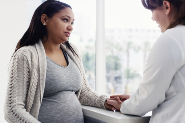 Pregnant Woman talking with doctor