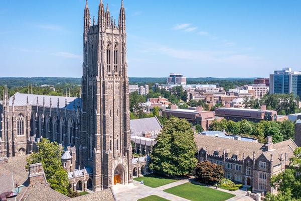 Duke Chapel with campus buildings and scenery from an aerial view.