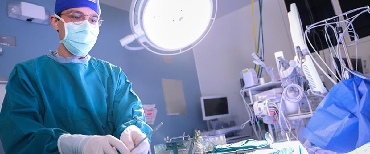 Surgeon with instruments in OR
