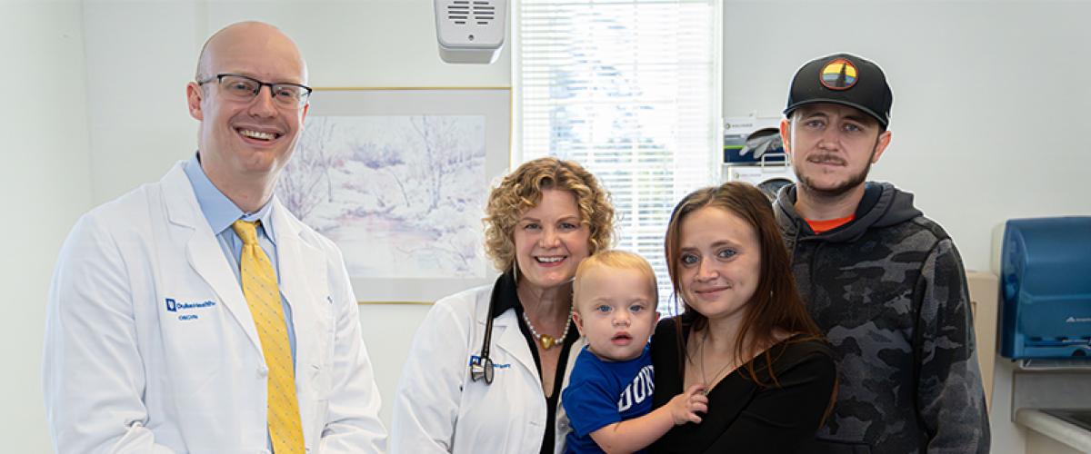 Doctors and patient with baby in clinic.