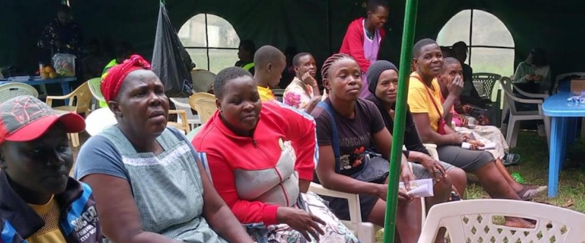 A group of women listen to education about cervical cancer and screening from a CHV at a health fair in the Gem Sub-County, outside of Kisumu, in Siaya County earlier this year. Credit: Dr. Megan Huchko