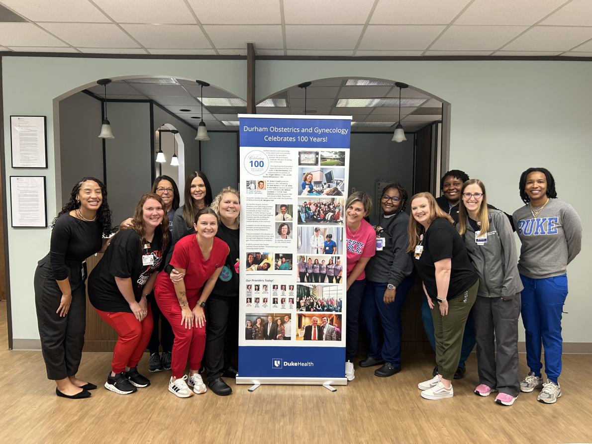 Group of people in front of retractable banner.