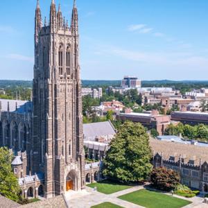 Duke Chapel with campus buildings and scenery from an aerial view.